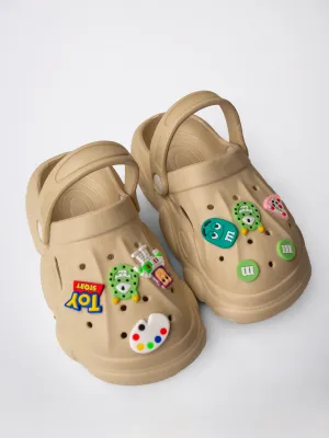 CLOGS WITH TOY-THEMED CHARMS