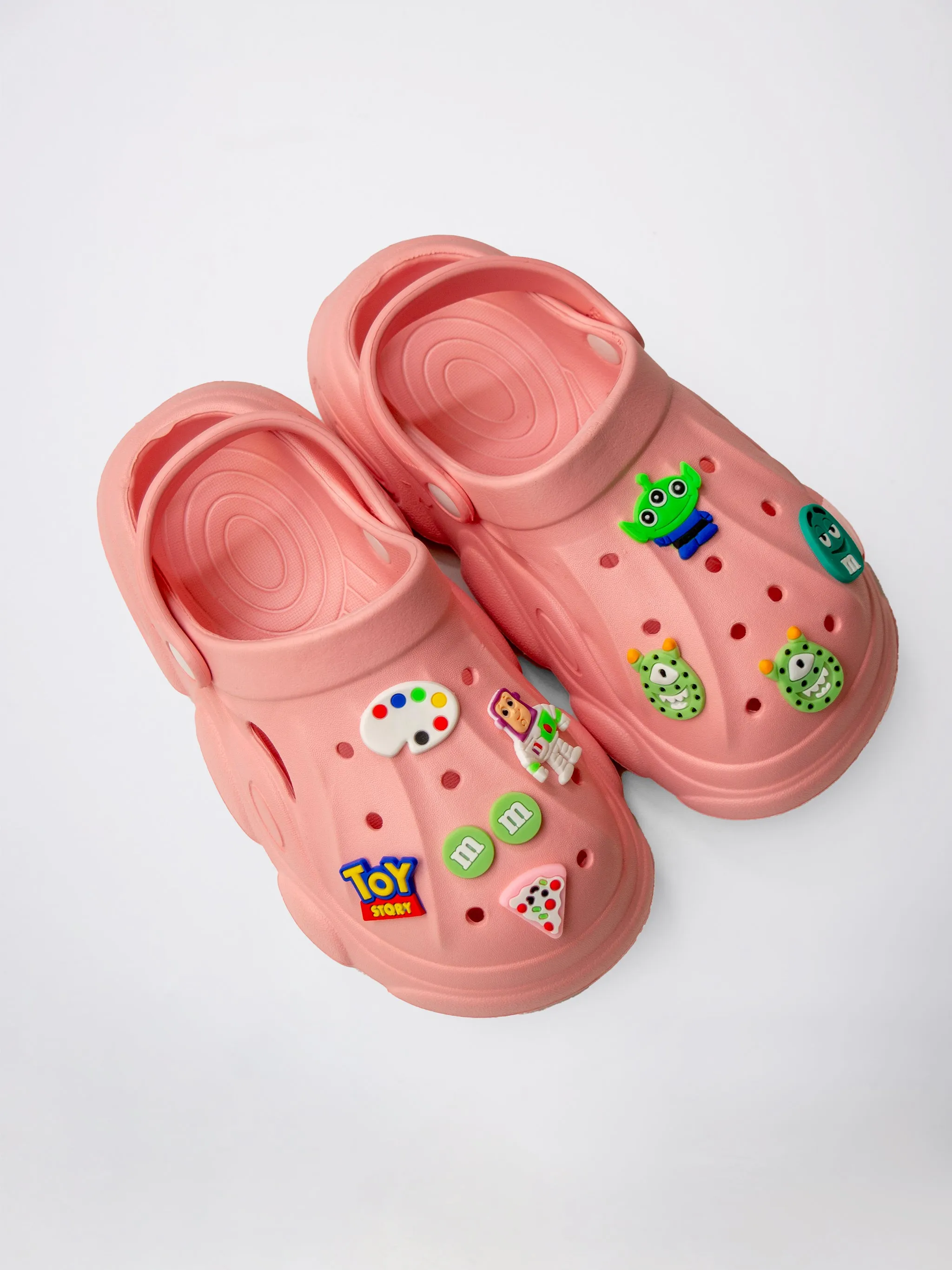CLOGS WITH TOY-THEMED CHARMS